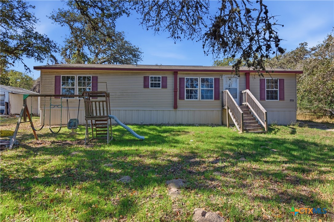 780 Oak Tree Road Seguin, TX 78155 - Photo 2 of 40 a front view of house with a garden and patio