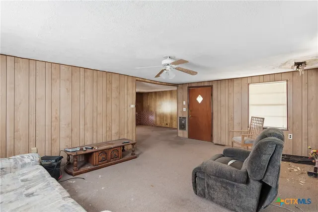 a view of a livingroom with furniture and windows