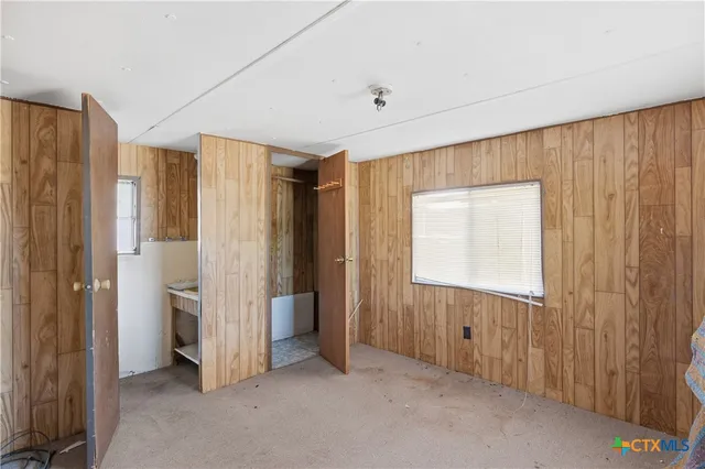 a view of entryway with wooden floor and cabinet