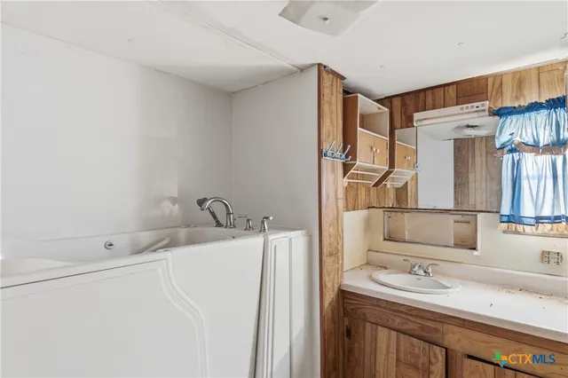 a bathroom with a sink and a mirror