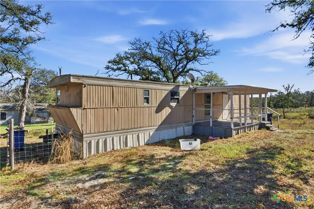 a view of a house with wooden fence