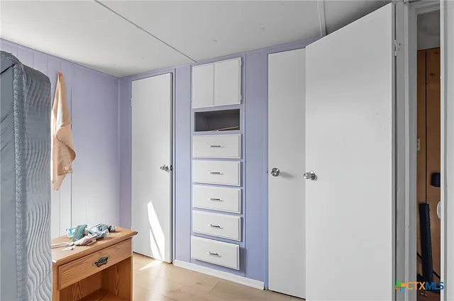 a view of room with cabinet and flat screen tv