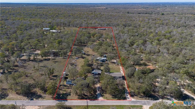 an aerial view of house with yard