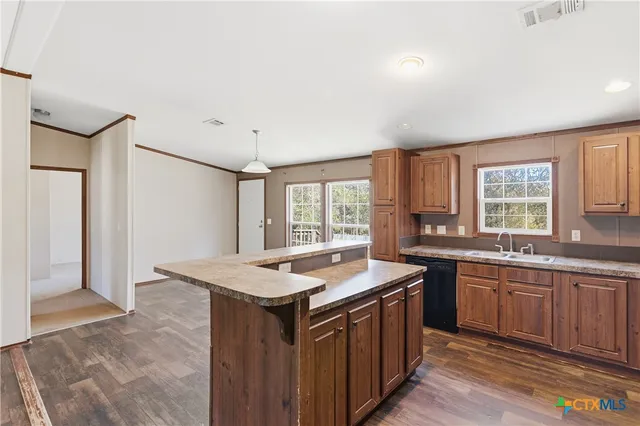 a kitchen that has a sink and a stove in it