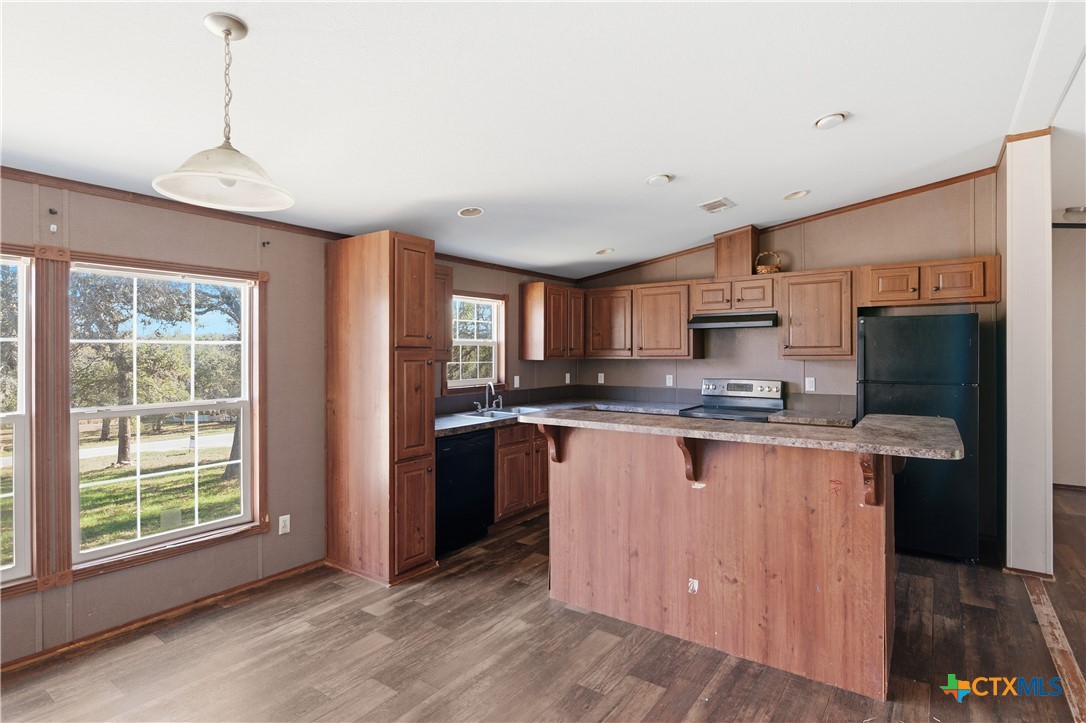 780 Oak Tree Road Seguin, TX 78155 - Photo 5 of 40 a large kitchen with stainless steel appliances granite countertop a sink a stove a refrigerator a center island and a window