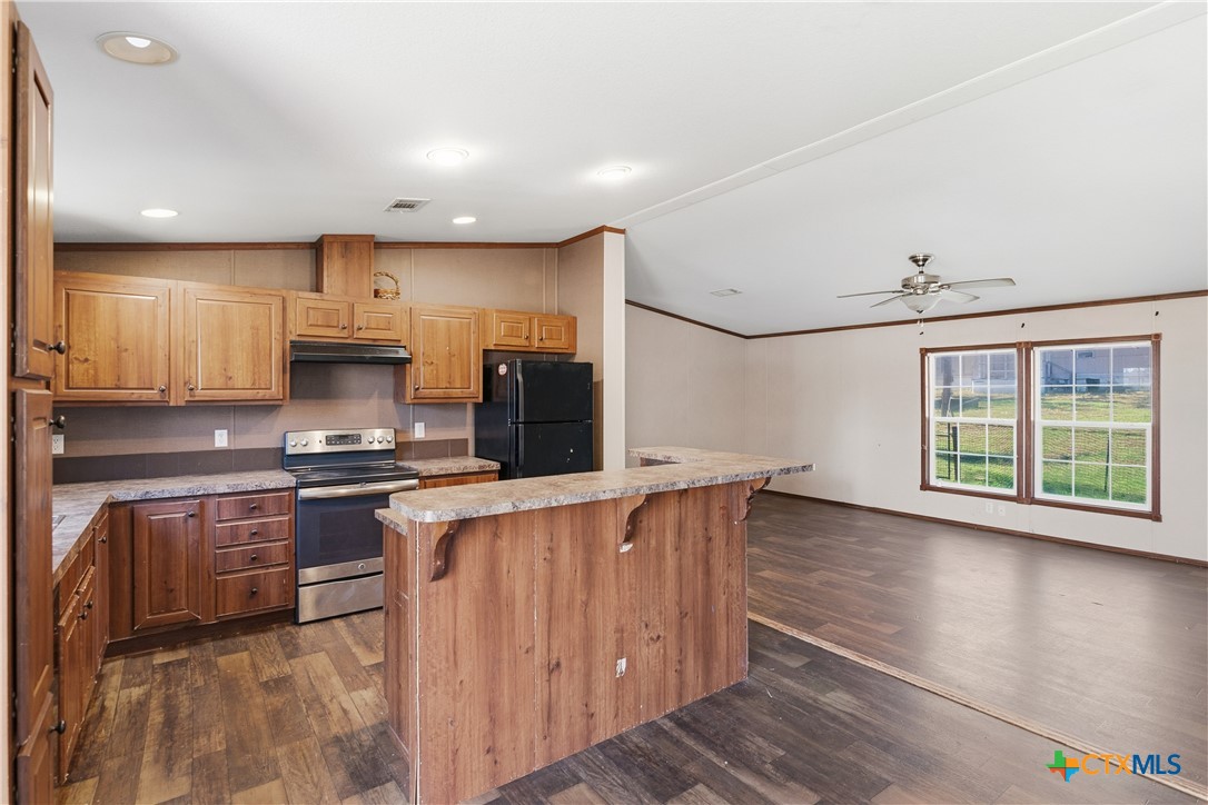 780 Oak Tree Road Seguin, TX 78155 - Photo 6 of 40 a kitchen with stainless steel appliances granite countertop a stove a sink and a refrigerator