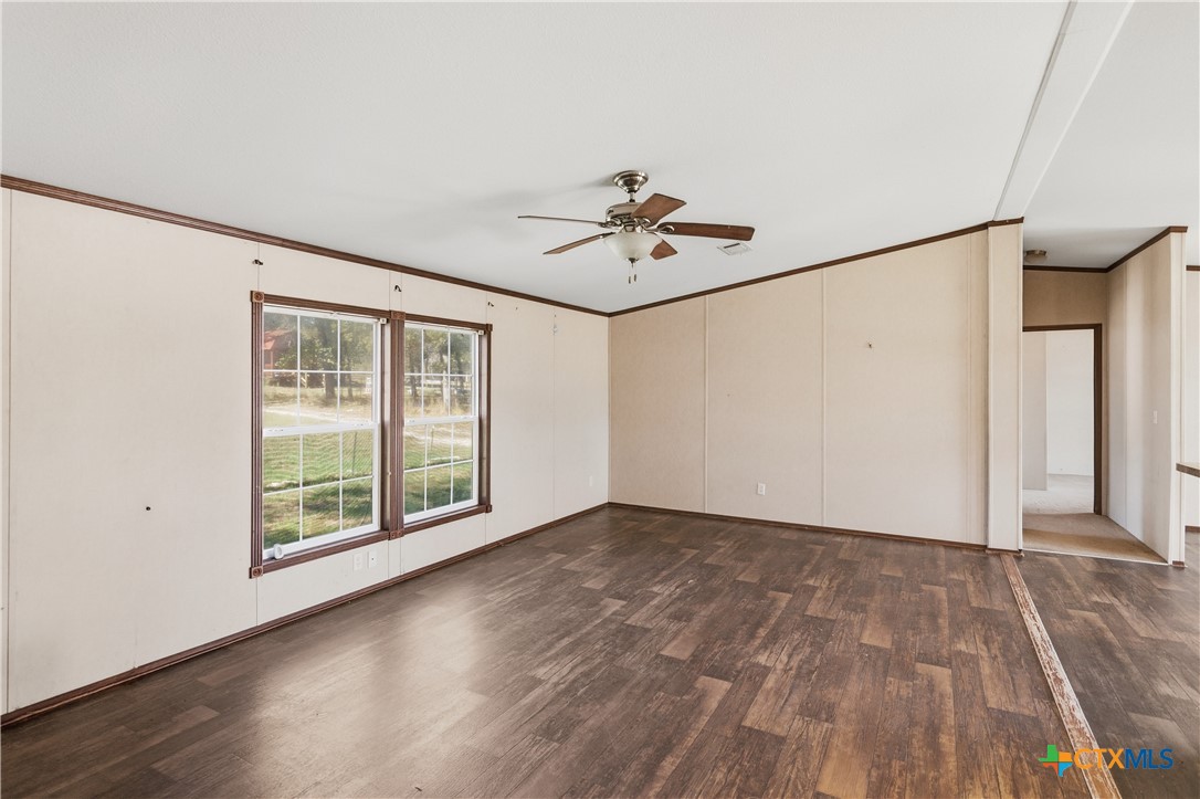 780 Oak Tree Road Seguin, TX 78155 - Photo 10 of 40 a view of an empty room with a window and wooden floor
