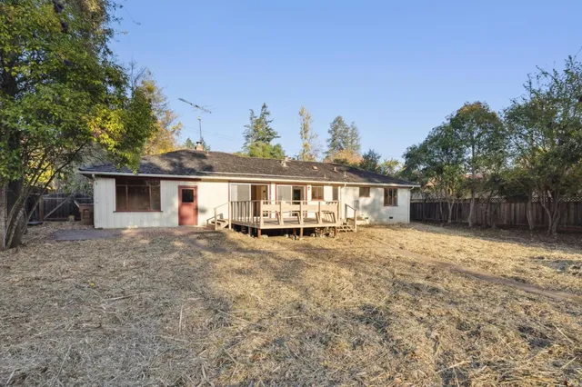 a view of a house with a yard and sitting area