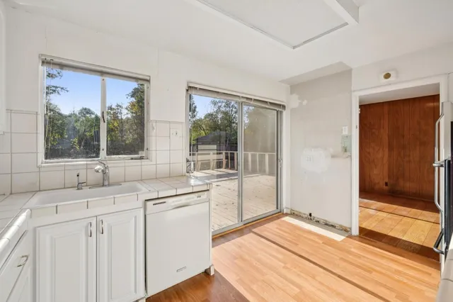 a kitchen with a sink and large window