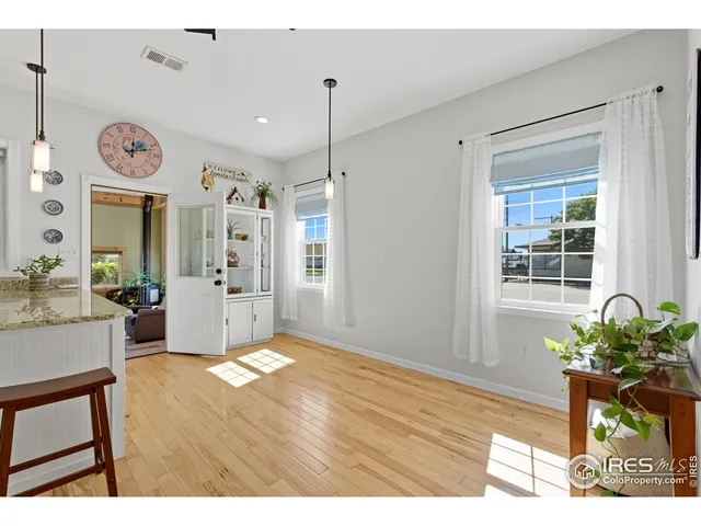 a view of an entryway with wooden floor