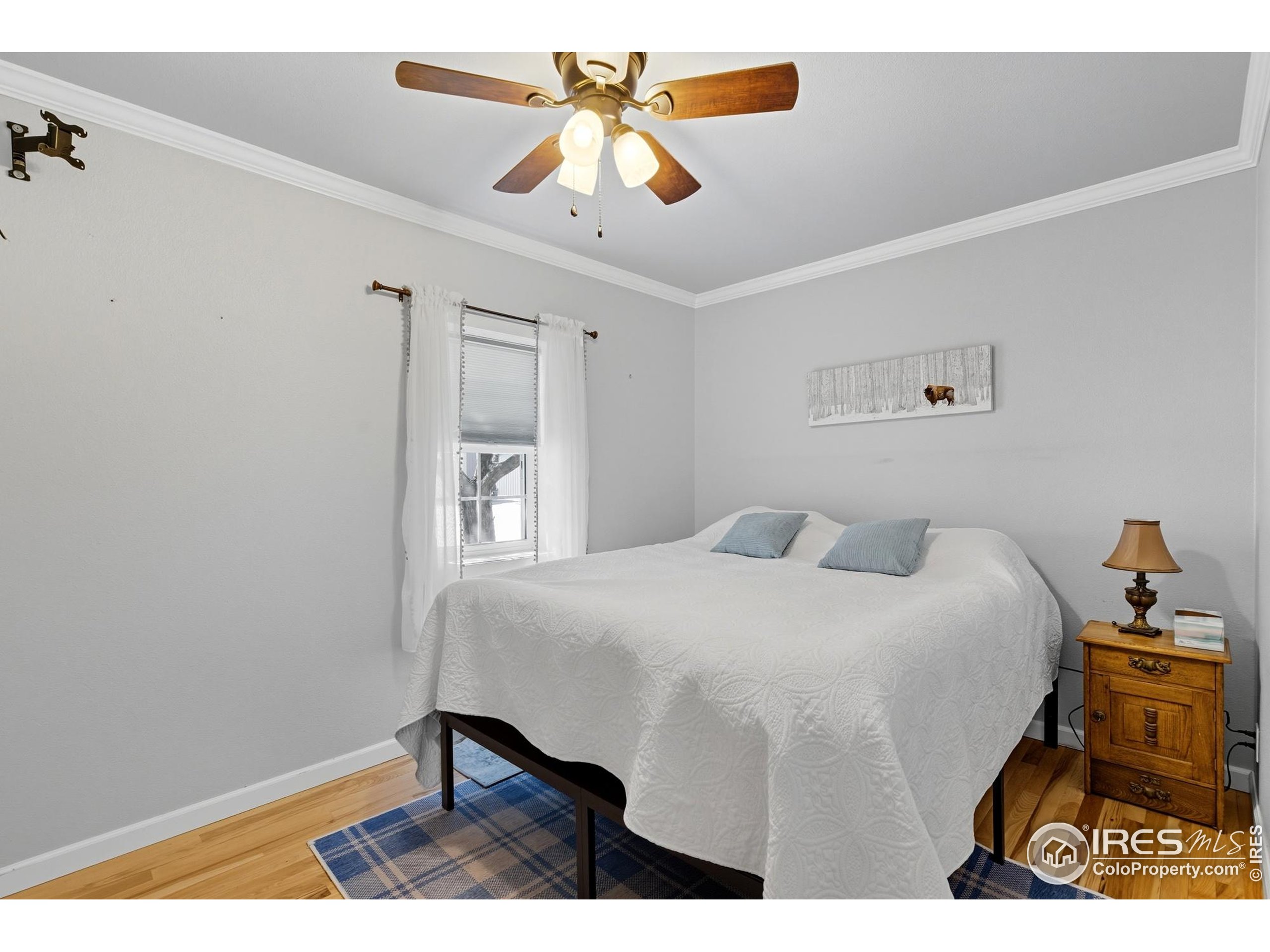 103 West Main Street Pierce, CO 80650 - Photo 15 of 47 a bedroom with a bed and a table