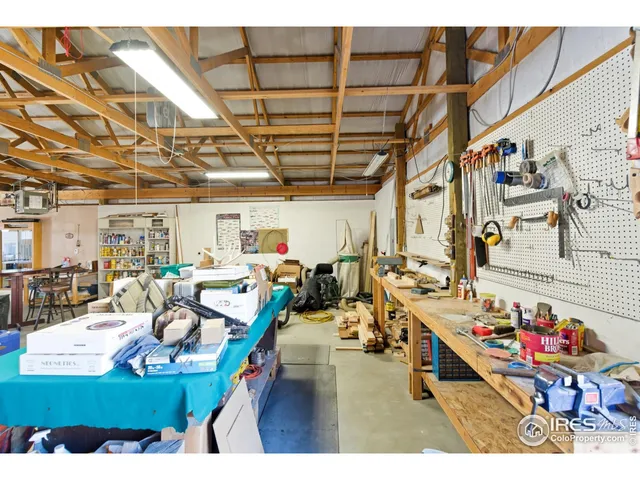 a living room with lots of furniture and clutter