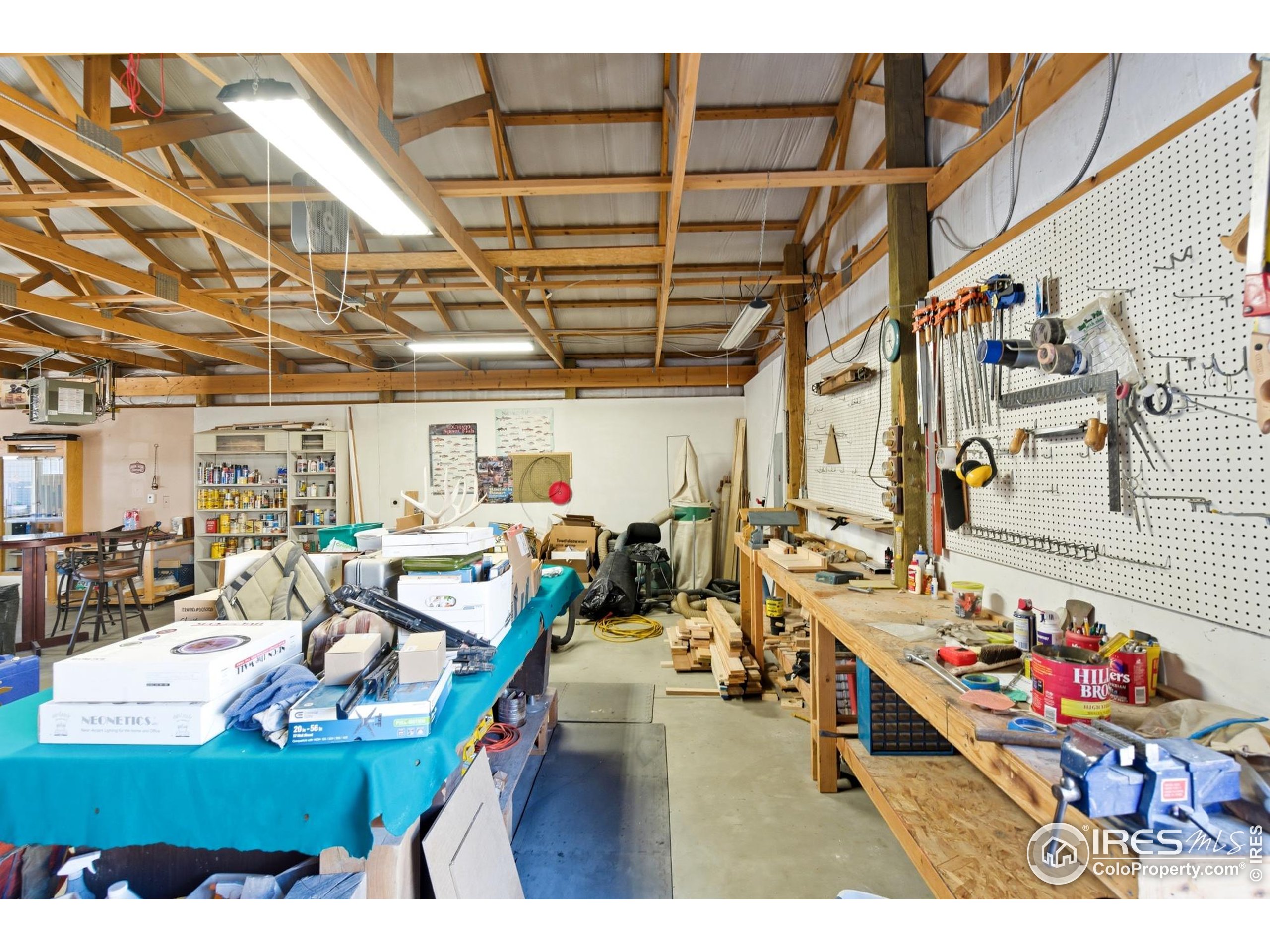 103 West Main Street Pierce, CO 80650 - Photo 36 of 47 a living room with lots of furniture and clutter