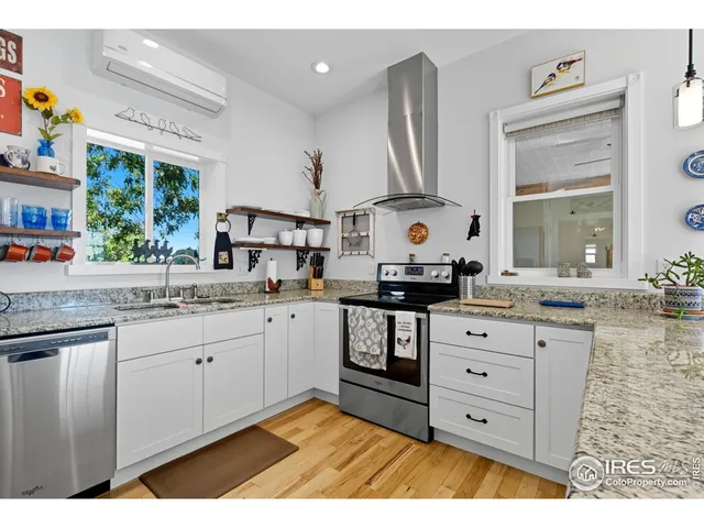 a kitchen with granite countertop a sink stainless steel appliances and cabinets