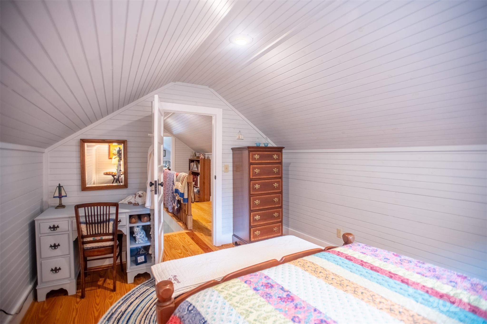 296 Sparks Road Bakersville, NC 28705 - Photo 14 of 47 a bedroom with a bed and wooden floor