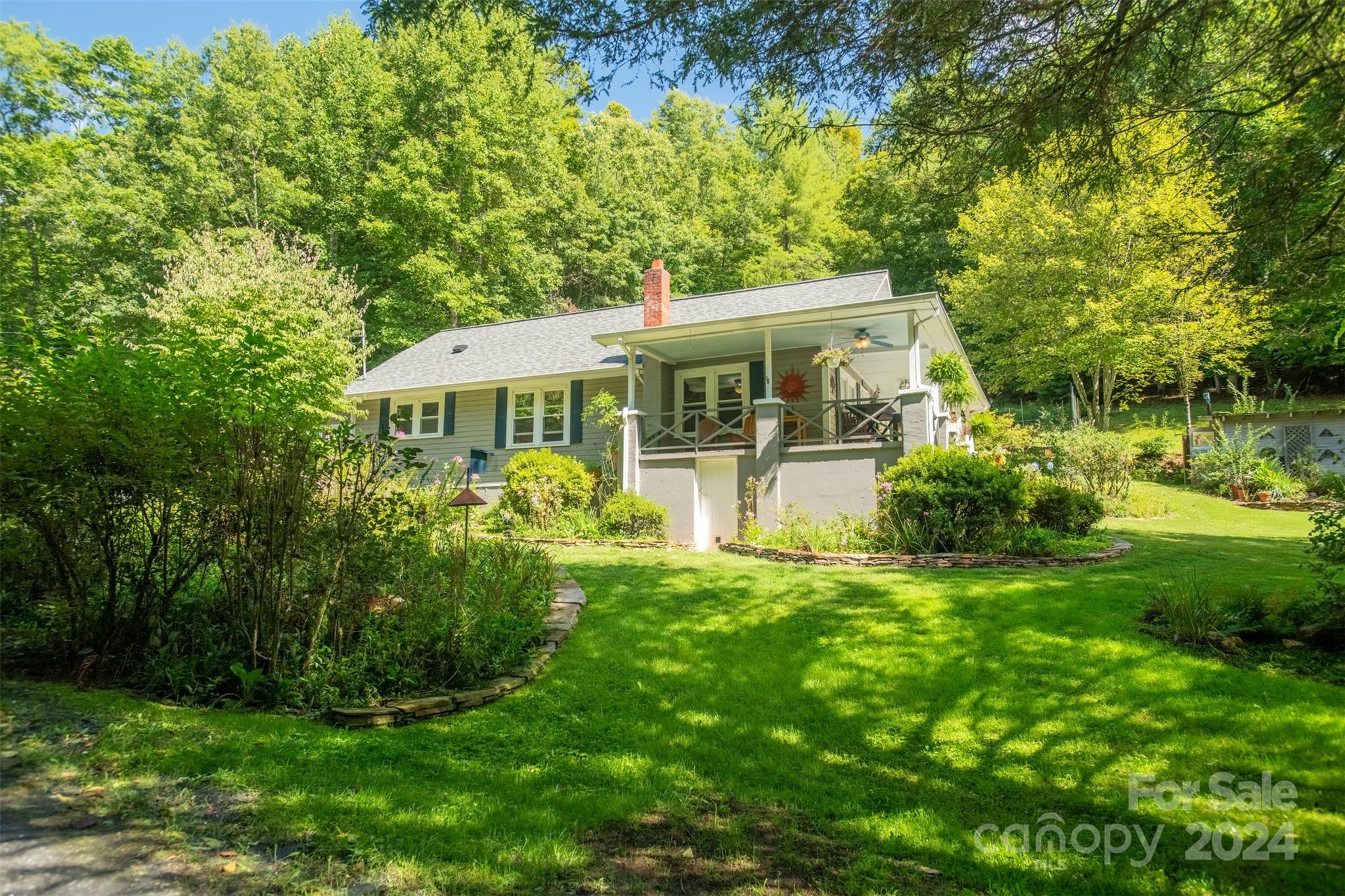 296 Sparks Road Bakersville, NC 28705 - Photo 17 of 47 a view of a house with a garden