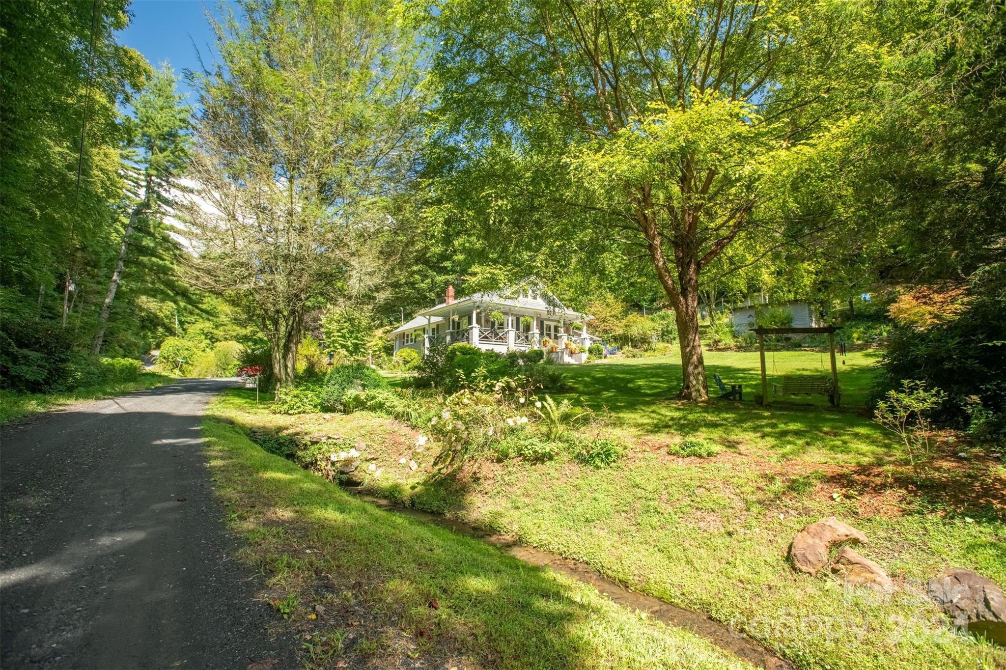 296 Sparks Road Bakersville, NC 28705 - Photo 18 of 47 a backyard of a house with lots of green space