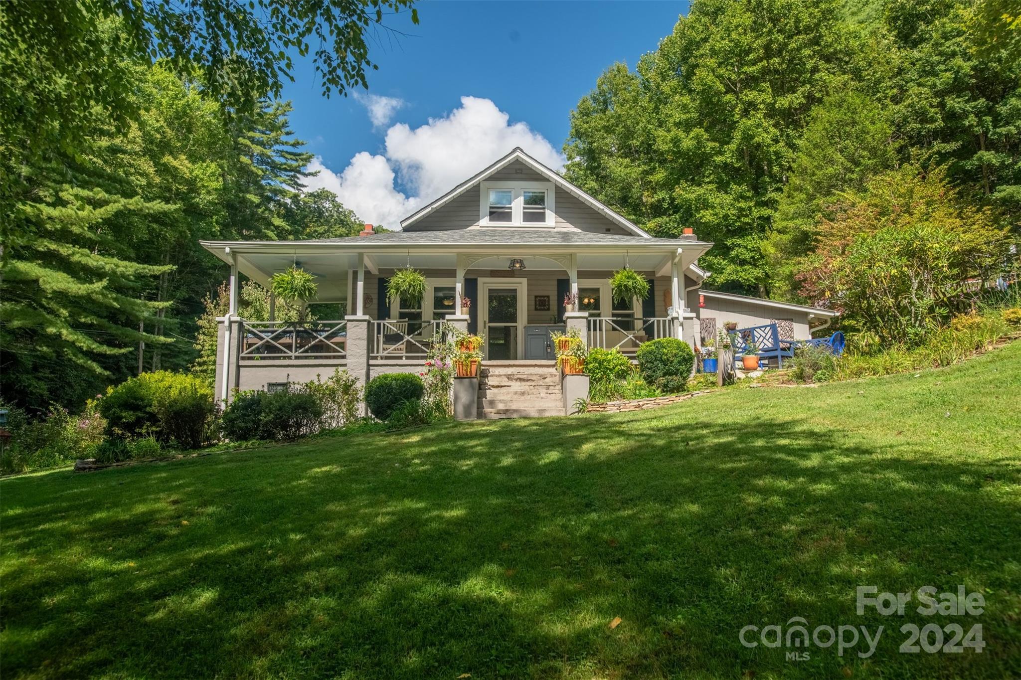 296 Sparks Road Bakersville, NC 28705 - Photo 19 of 47 a front view of a house with a yard table and chairs