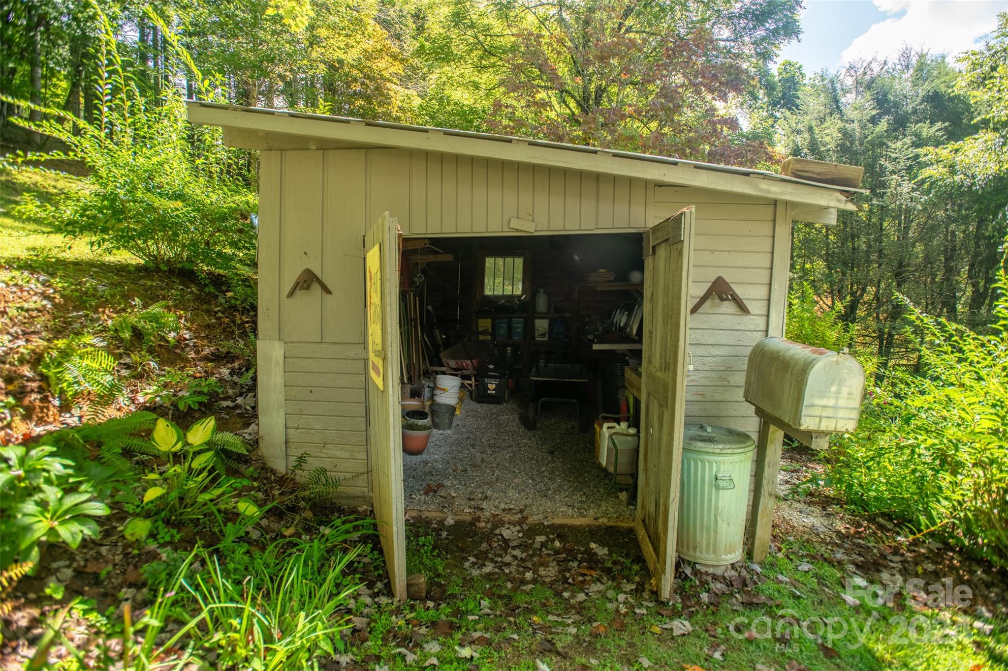296 Sparks Road Bakersville, NC 28705 - Photo 22 of 47 a view of a porch with a table and chairs and potted plants