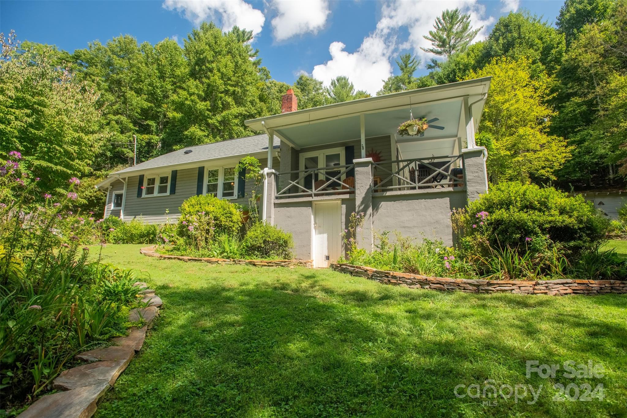 296 Sparks Road Bakersville, NC 28705 - Photo 24 of 47 a front view of house with yard and trees in the background