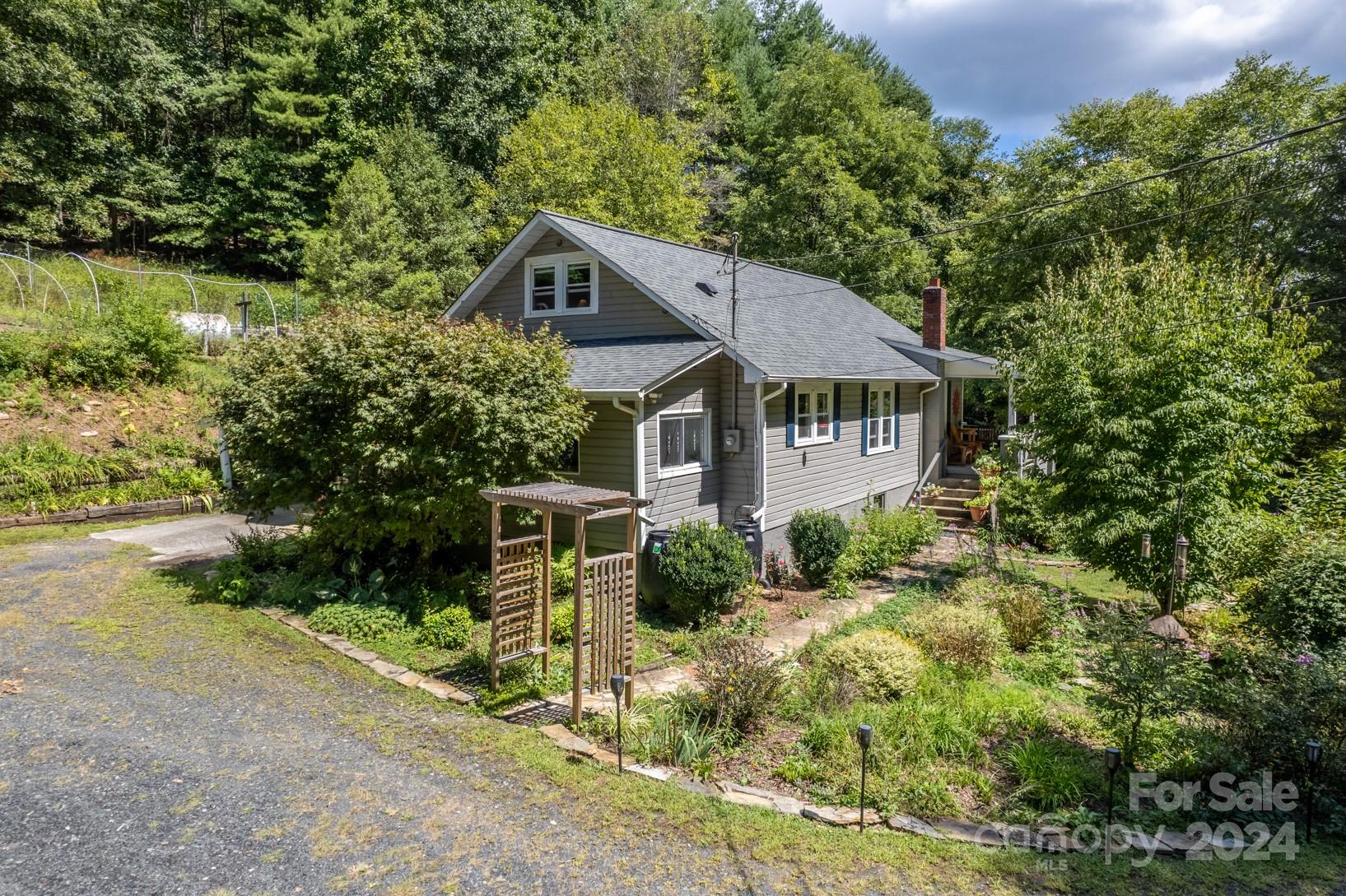 296 Sparks Road Bakersville, NC 28705 - Photo 27 of 47 a view of a house with garden and plants