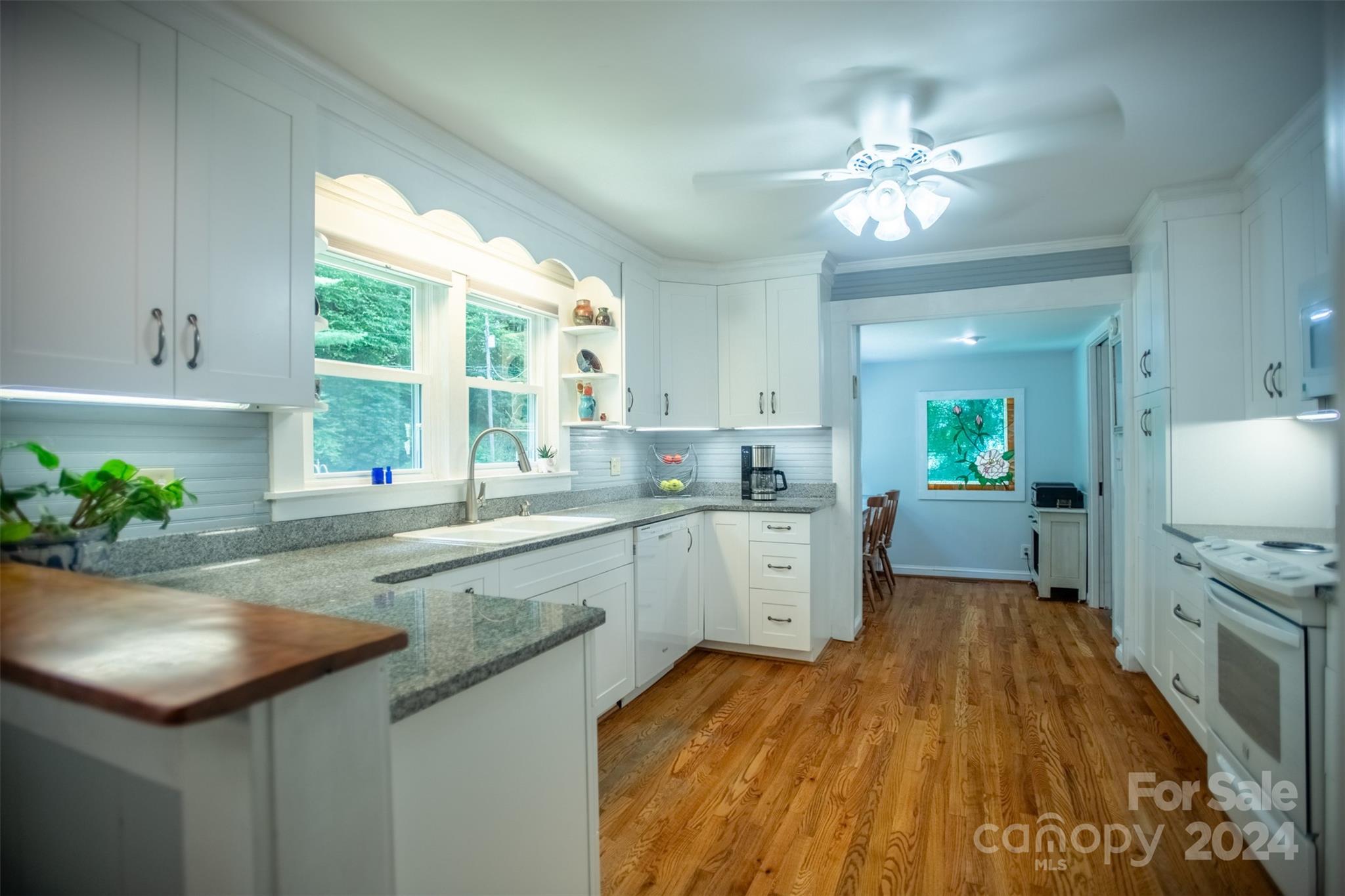 296 Sparks Road Bakersville, NC 28705 - Photo 3 of 47 a kitchen with a sink a counter top space appliances and a window