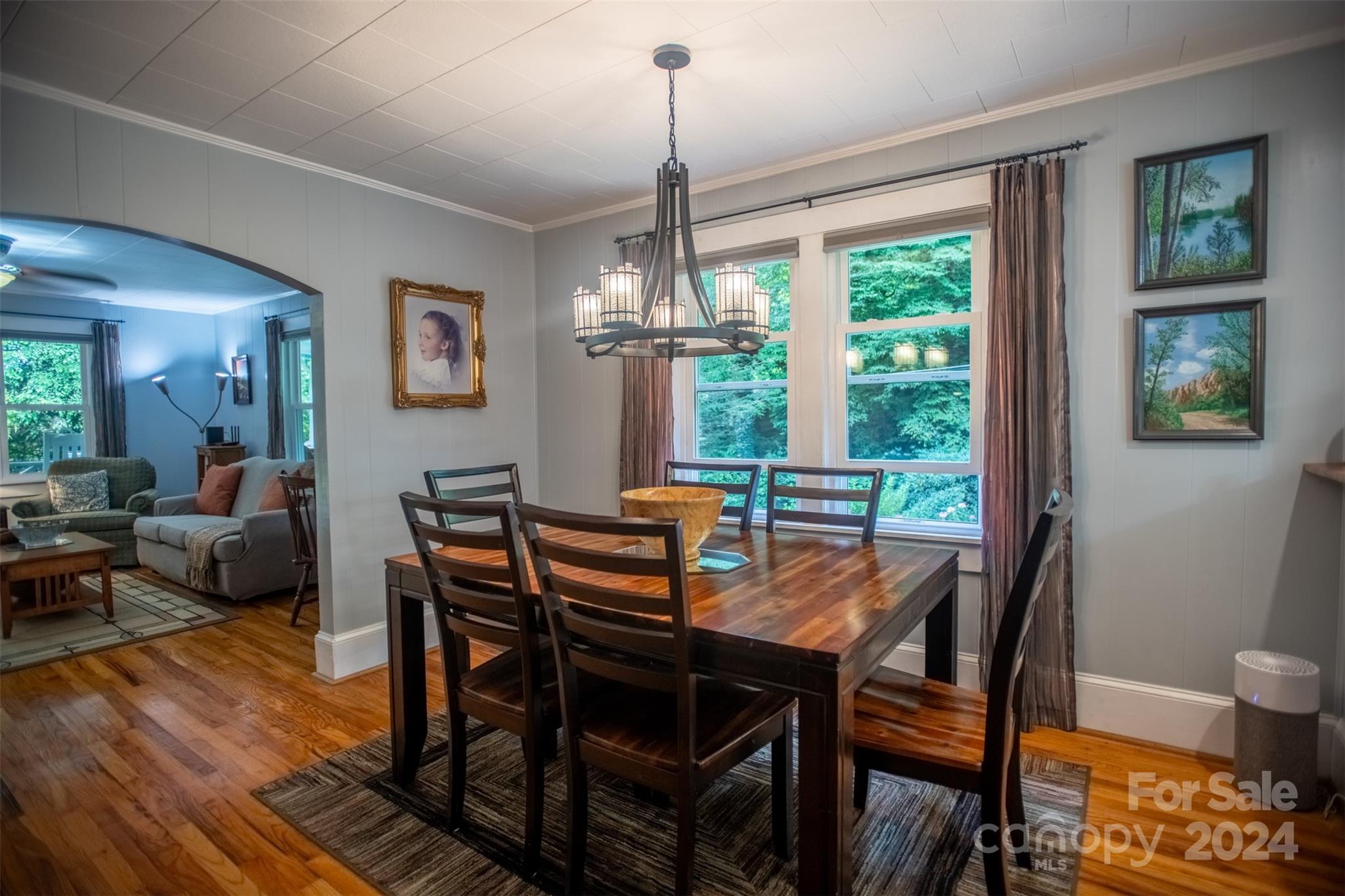 296 Sparks Road Bakersville, NC 28705 - Photo 31 of 47 a dining room with furniture a chandelier and wooden floor