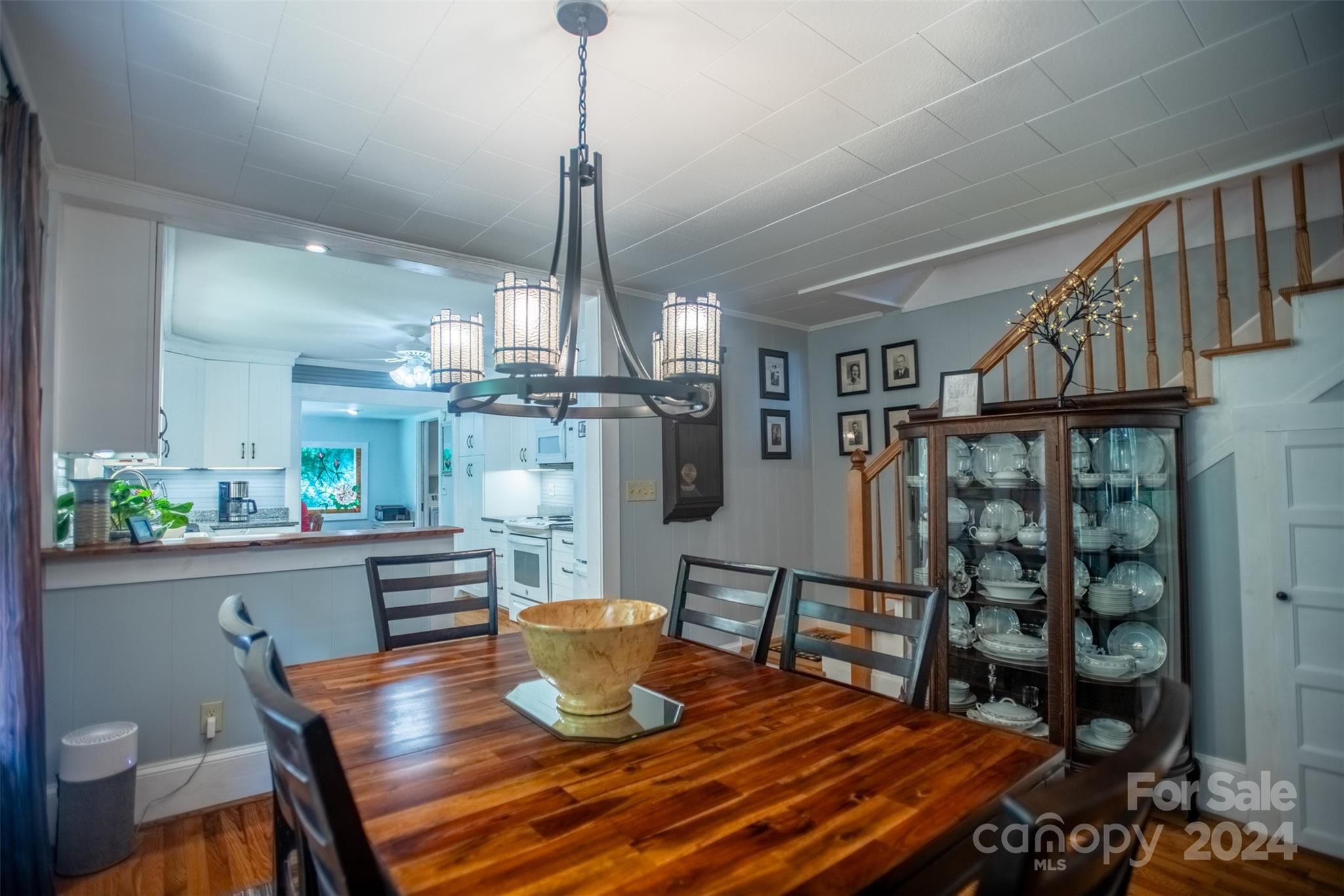 296 Sparks Road Bakersville, NC 28705 - Photo 32 of 47 a dining room with furniture a chandelier and wooden floor