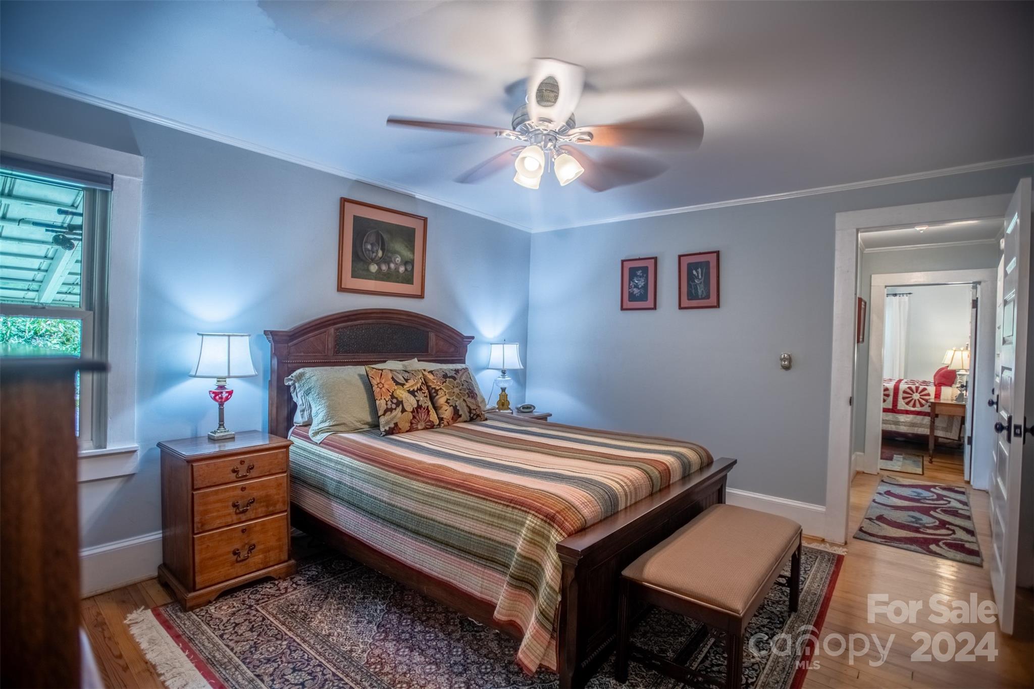 296 Sparks Road Bakersville, NC 28705 - Photo 43 of 47 a bedroom with a bed and a chandelier