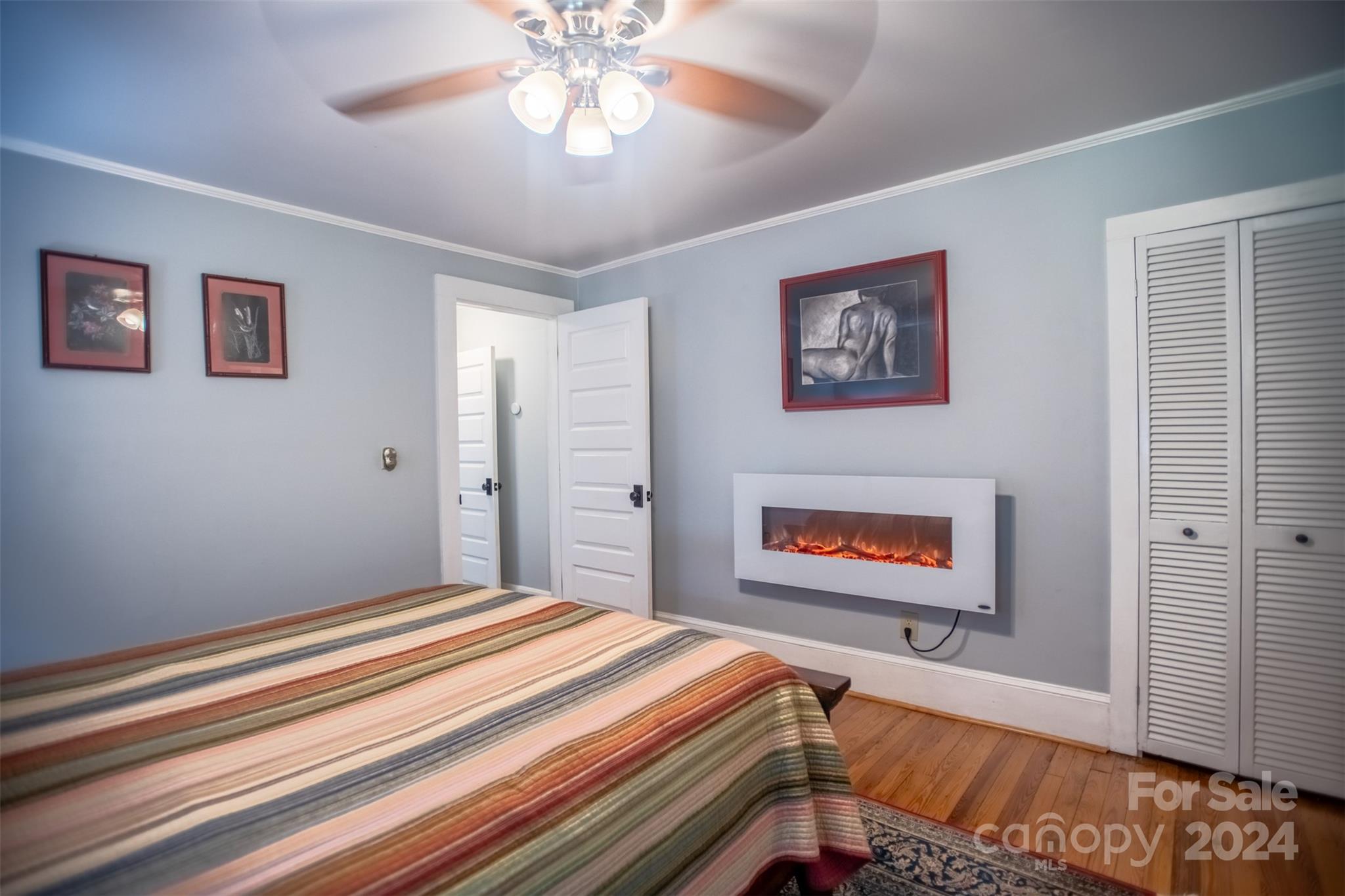 296 Sparks Road Bakersville, NC 28705 - Photo 44 of 47 a bedroom with a bed and a chandelier