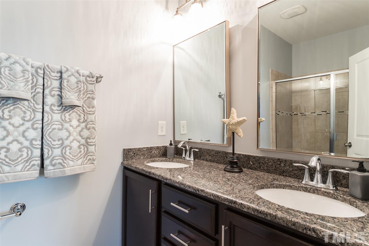 1611 Crafton Way Raleigh, NC 27607 - Photo 14 of 23 a bathroom with double vanity and a mirror