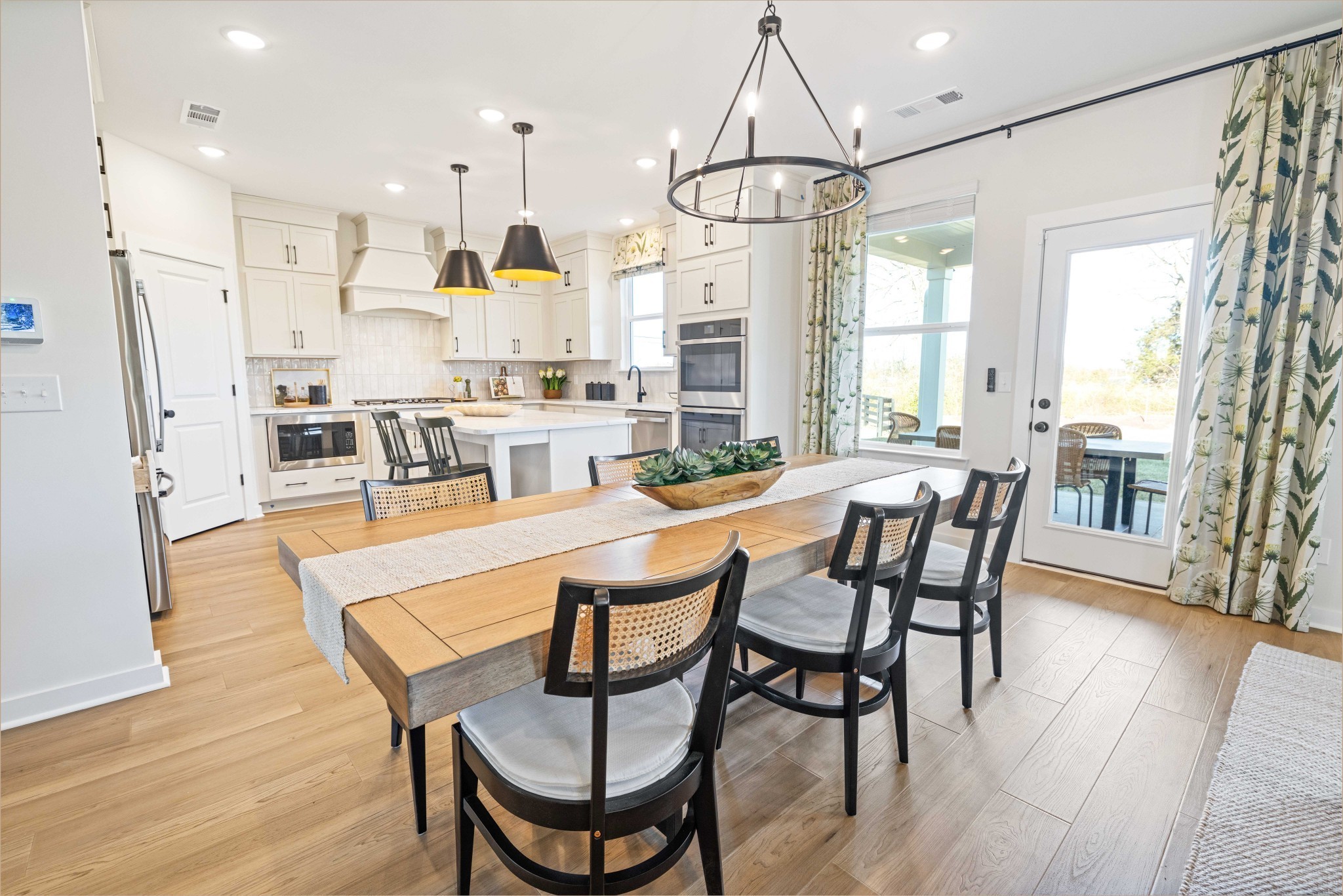 4166 Dream Beetle Loop Rockvale, TN 37153 - Photo 14 of 45 a dining room with furniture a chandelier and wooden floor