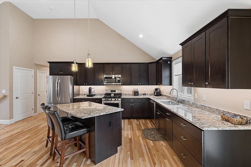 71 Dudley Hill Road Dudley, MA 01571 - Photo 11 of 32 a kitchen with granite countertop a sink stove and refrigerator