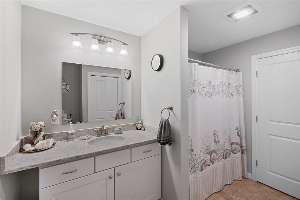 71 Dudley Hill Road Dudley, MA 01571 - Photo 13 of 32 a bathroom with a granite countertop sink a toilet a shower and a mirror