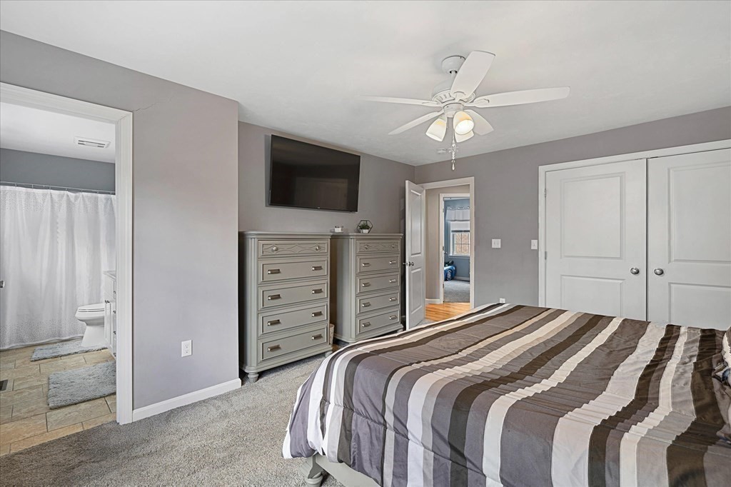 71 Dudley Hill Road Dudley, MA 01571 - Photo 15 of 32 a bedroom with a large bed and a tv