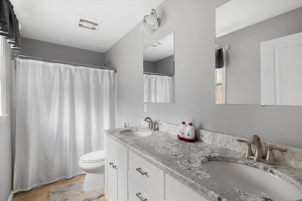 71 Dudley Hill Road Dudley, MA 01571 - Photo 16 of 32 a bathroom with a granite countertop sink and a mirror