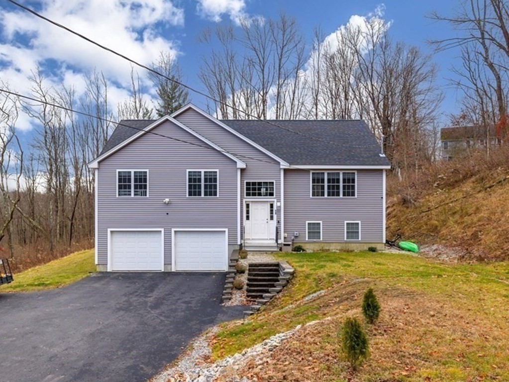 71 Dudley Hill Road Dudley, MA 01571 - Photo 2 of 32 a front view of a house with a yard