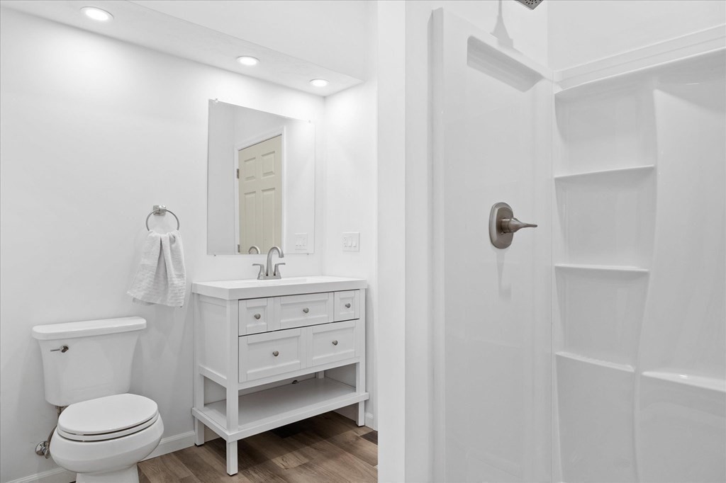 71 Dudley Hill Road Dudley, MA 01571 - Photo 25 of 32 a bathroom with a sink a toilet a mirror and shower