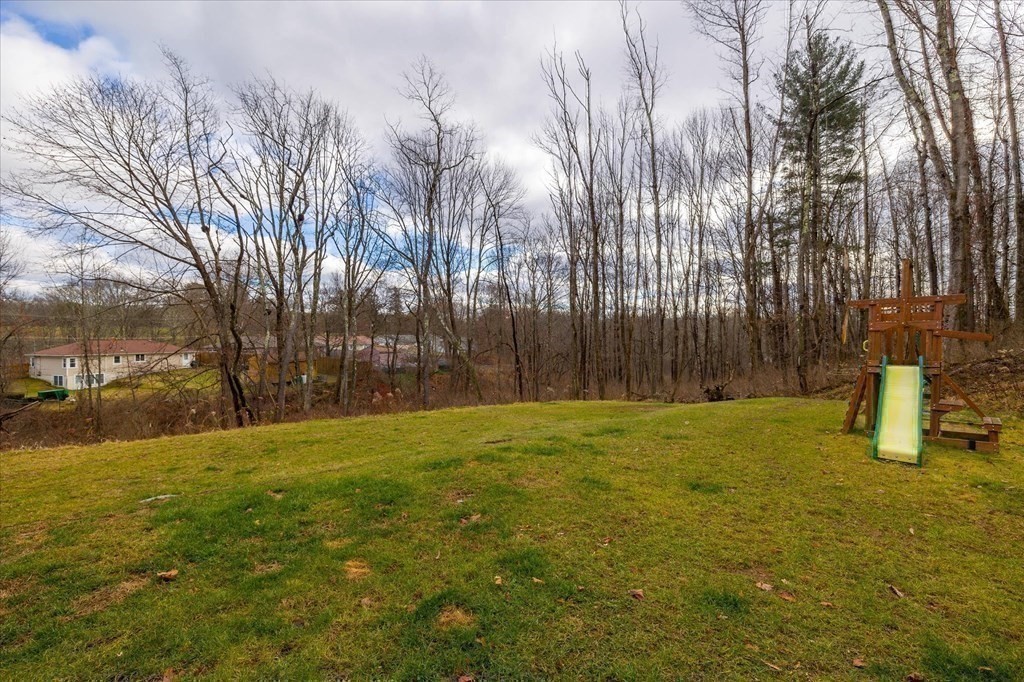 71 Dudley Hill Road Dudley, MA 01571 - Photo 27 of 32 a house with trees in front of it