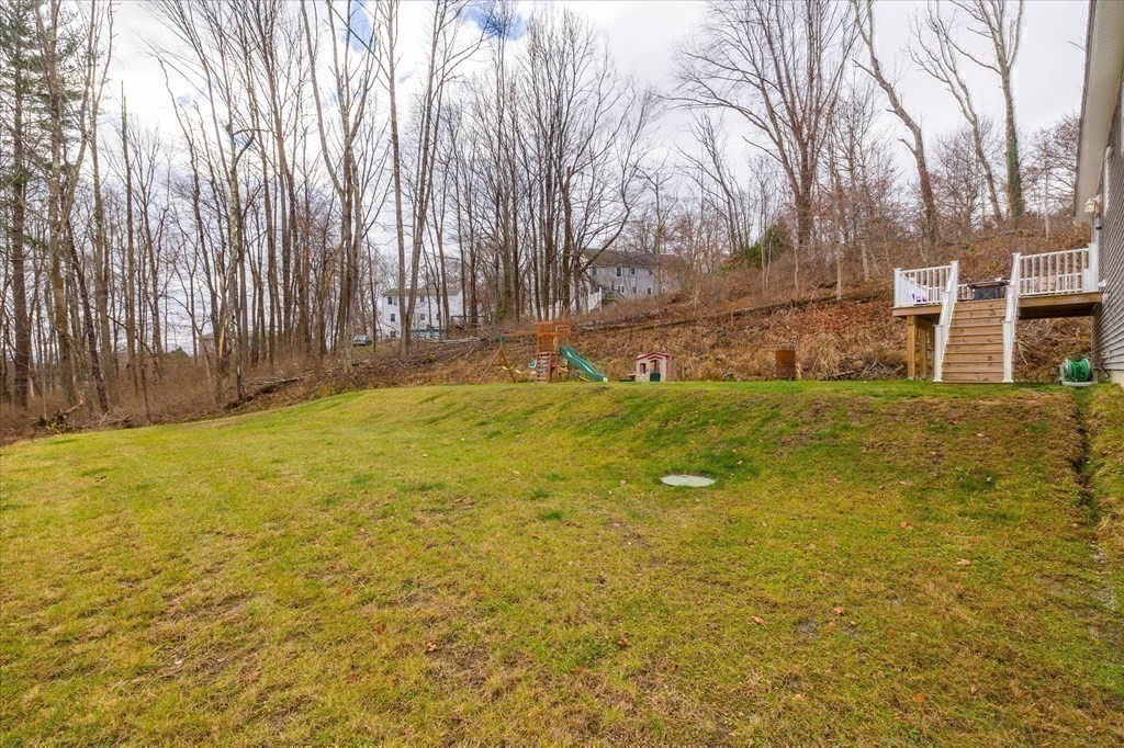 71 Dudley Hill Road Dudley, MA 01571 - Photo 28 of 32 a swimming pool with trees in front of it