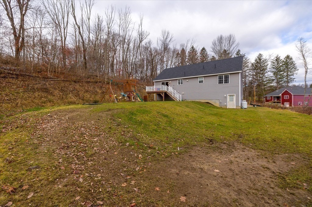 71 Dudley Hill Road Dudley, MA 01571 - Photo 29 of 32 a view of a house with a yard and garage