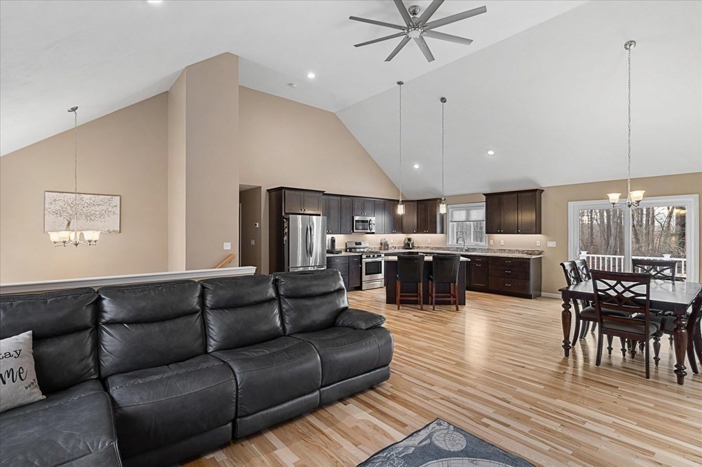 71 Dudley Hill Road Dudley, MA 01571 - Photo 6 of 32 a living room with furniture kitchen view and a wooden floor