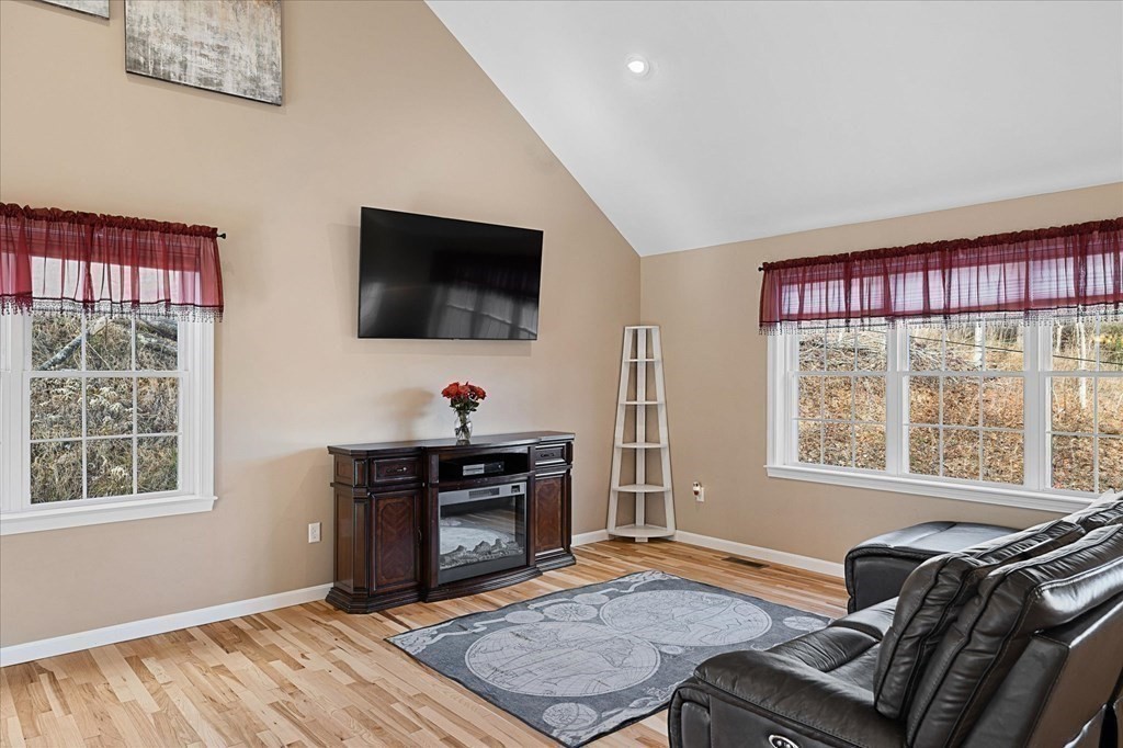 71 Dudley Hill Road Dudley, MA 01571 - Photo 7 of 32 a living room with furniture a flat screen tv and a window