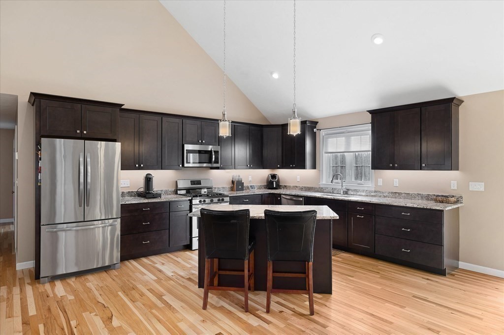 71 Dudley Hill Road Dudley, MA 01571 - Photo 10 of 32 a kitchen with granite countertop a sink appliances a counter space and cabinets