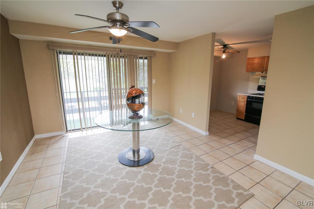 1575 Creekside Road, Unit A5 Whitehall, PA 18052 - Photo 7 of 24 a view of a livingroom with a chandelier fan and windows