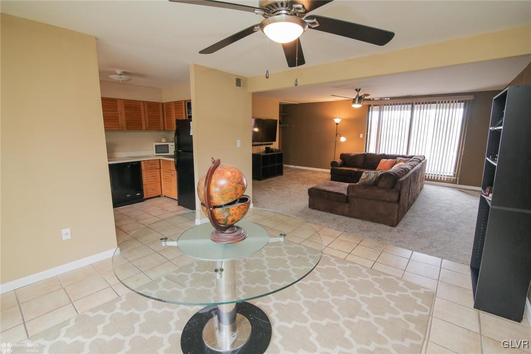 1575 Creekside Road, Unit A5 Whitehall, PA 18052 - Photo 8 of 24 a living room with couches and kitchen view with wooden floor