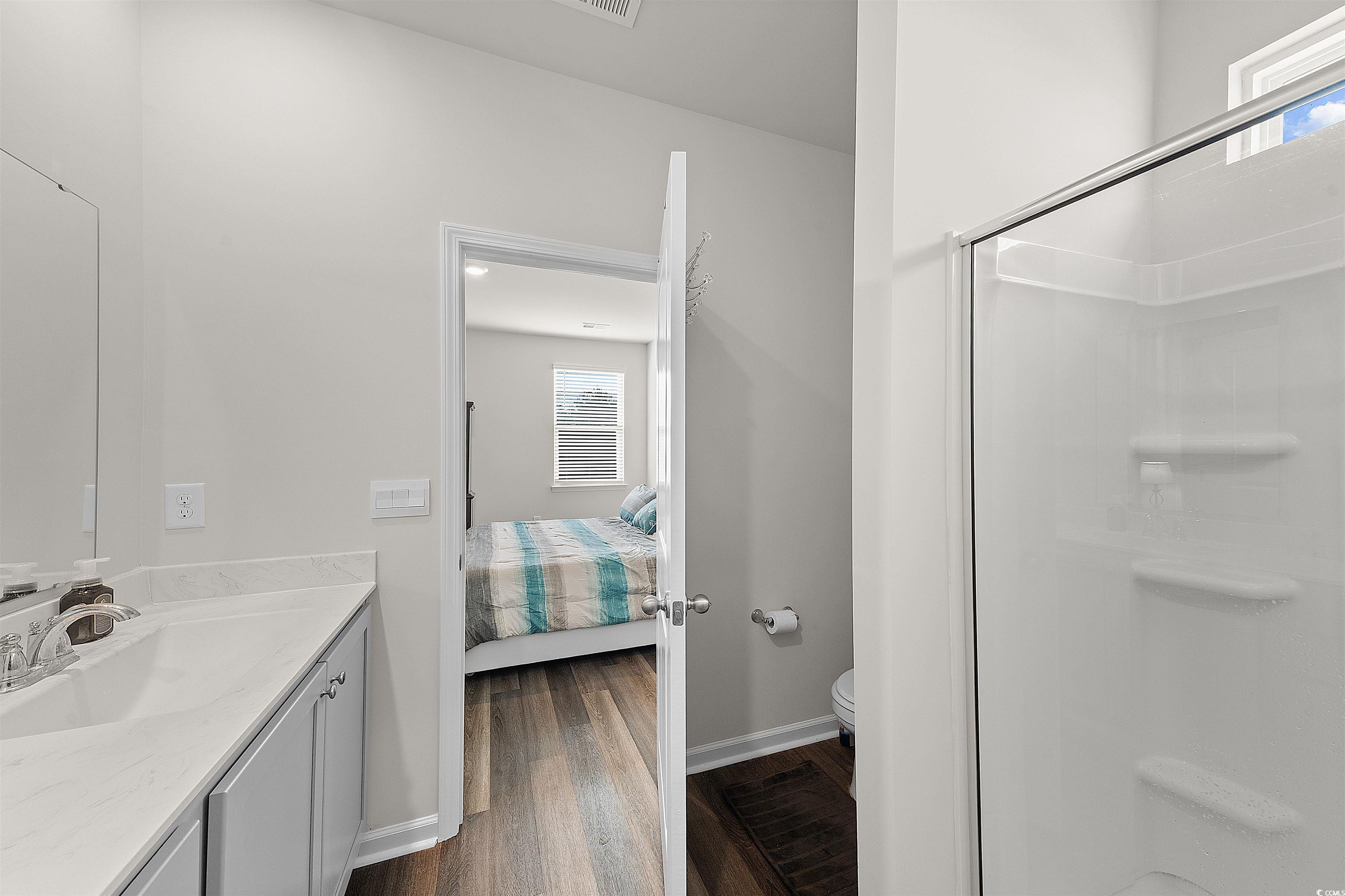 3119 Fair Rdg Way Conway, SC 29526 - Photo 15 of 38 Bathroom featuring wood finished floors, vanity, a shower, and ensuite bath