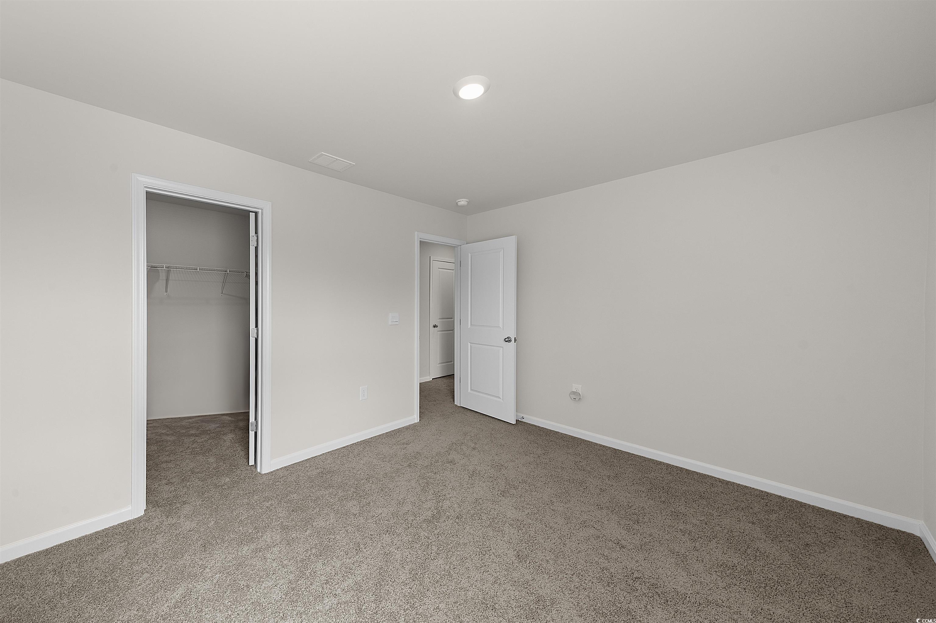 3119 Fair Rdg Way Conway, SC 29526 - Photo 26 of 38 Unfurnished bedroom featuring carpet floors and a walk in closet