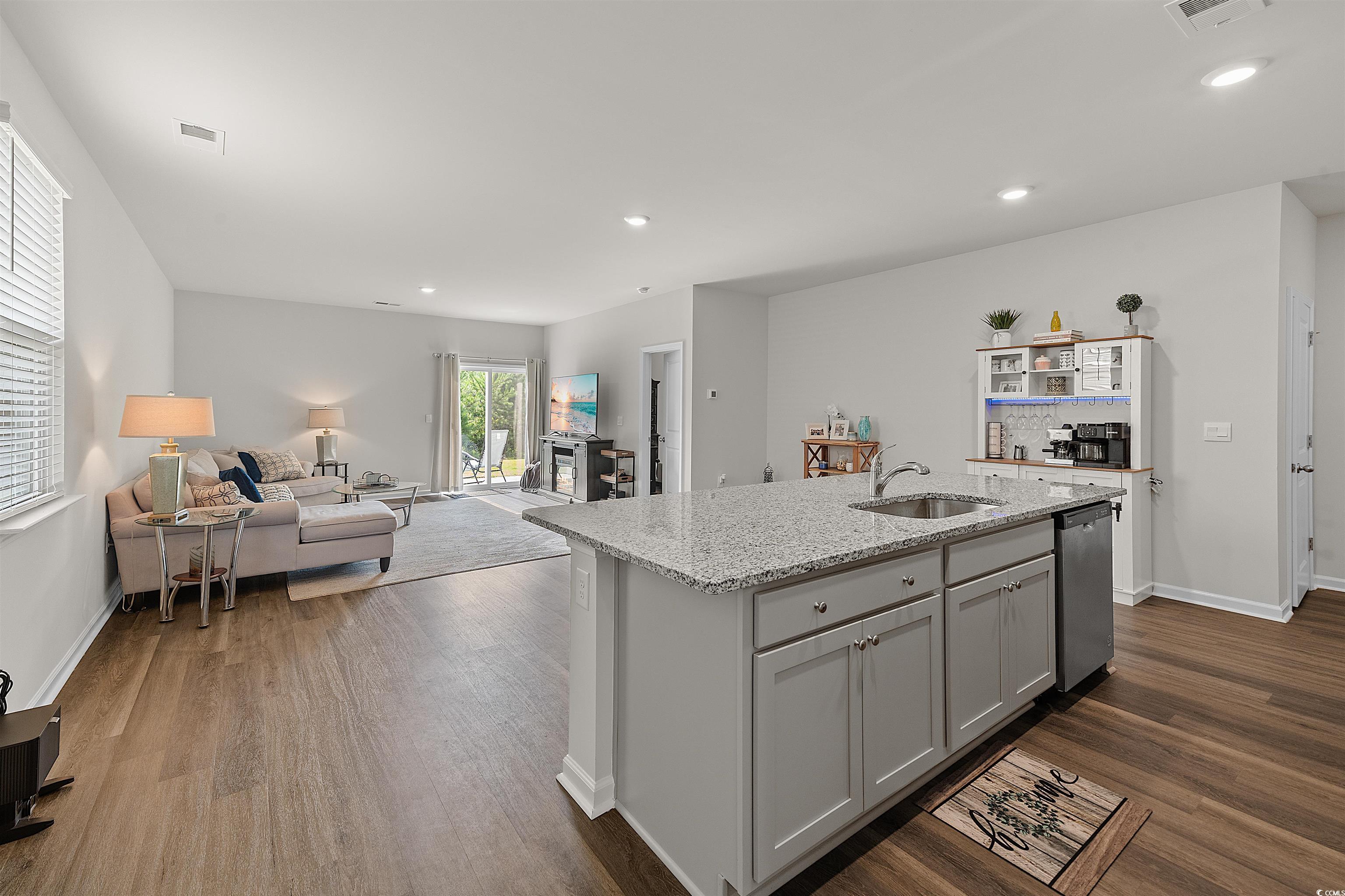 3119 Fair Rdg Way Conway, SC 29526 - Photo 38 of 38 Kitchen with recessed lighting, light stone countertops, an island with sink, open floor plan, and dark wood-type flooring