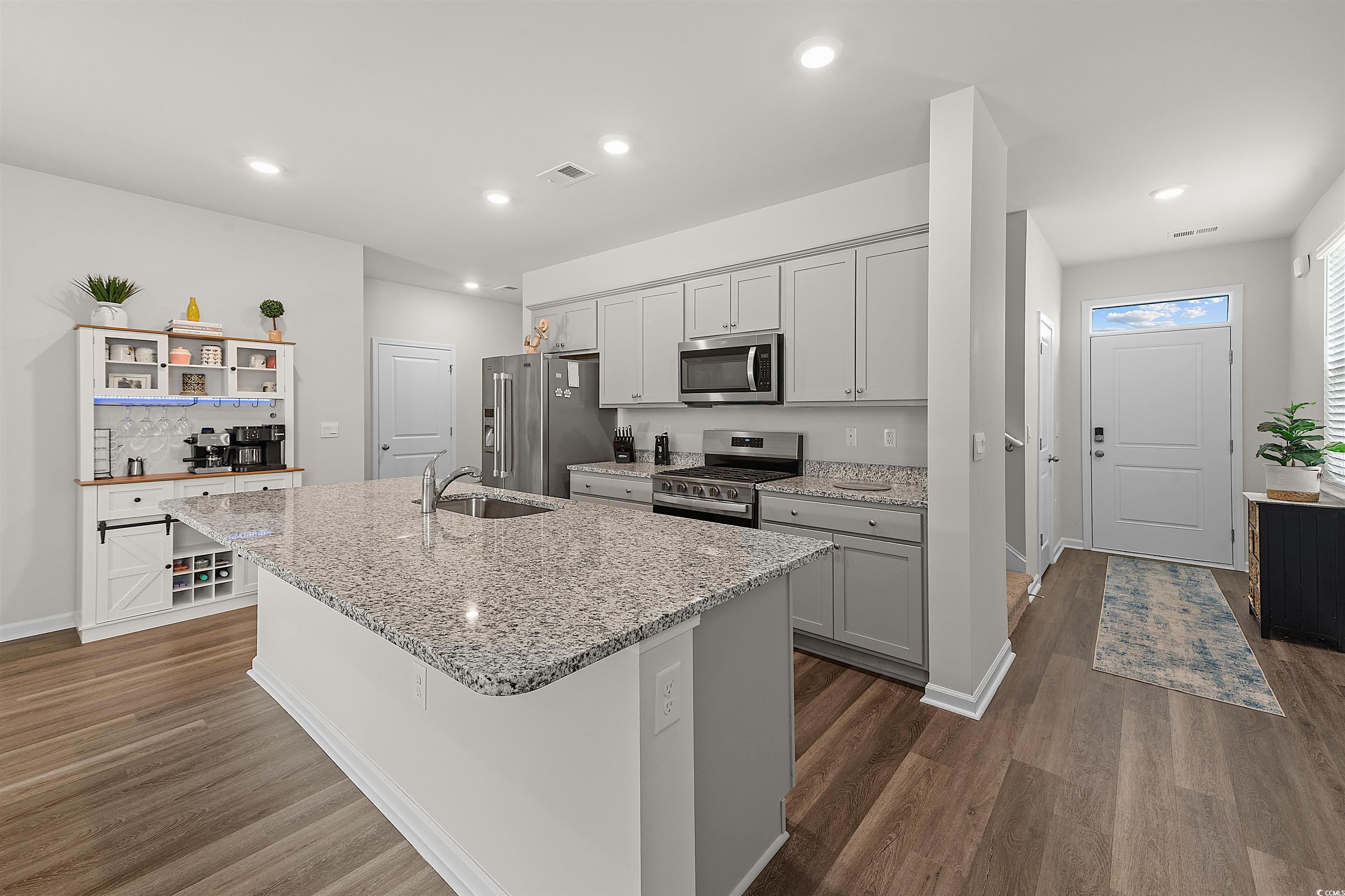 3119 Fair Rdg Way Conway, SC 29526 - Photo 7 of 38 Kitchen featuring open shelves, appliances with stainless steel finishes, an island with sink, dark wood-style floors, and recessed lighting